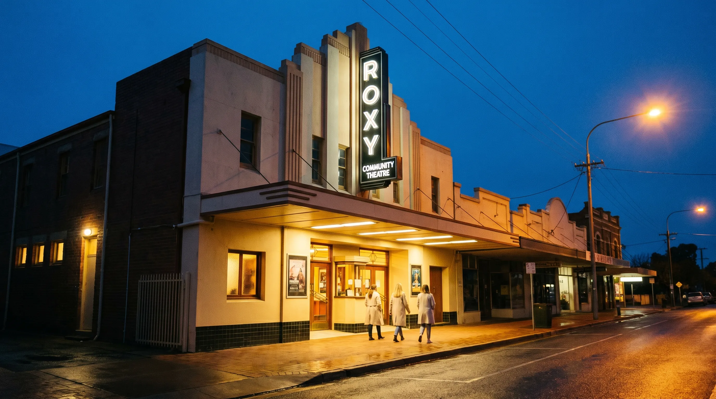 Roxy Community Theatre Art Deco facade on Pine Avenue Leeton at blue hour, marquee illuminated